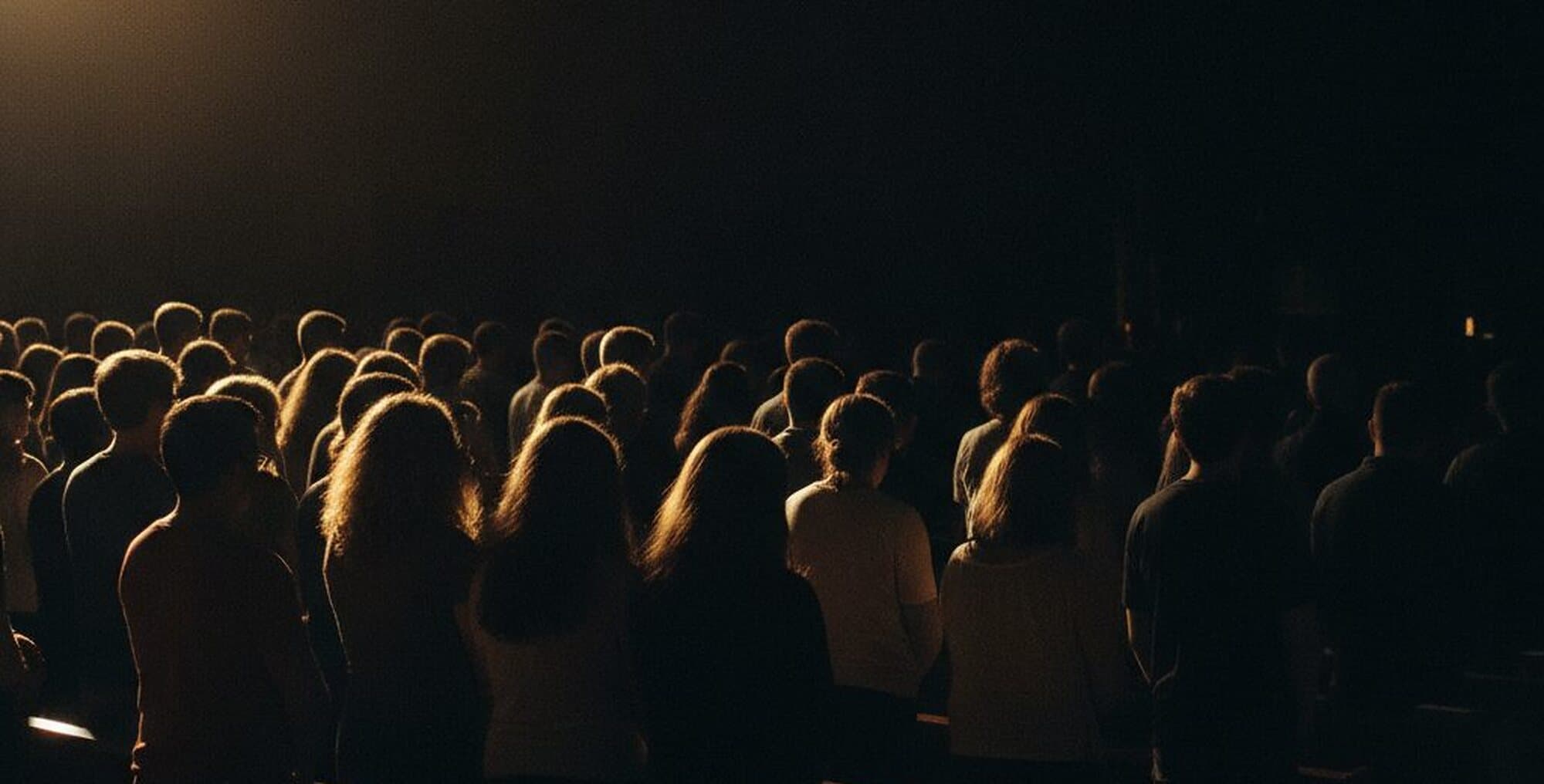 The congregation of Testimony Arena standing together during a Wednesday evening gathering in Herten, seen from behind